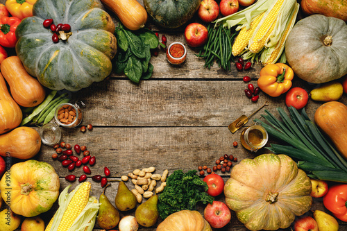 Pile of colorful fruits and vegetables on wooden background