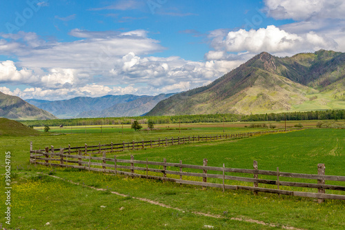 The fenced valley in the foothills of Altai against the backdrop of a beautiful sky