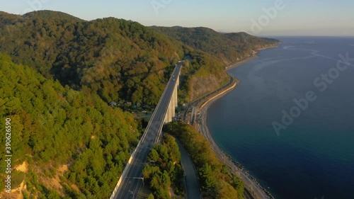 large bridge for motorway across sea, aerial view of drone slide turn, beautiful design of the automotive bridge in sea. Travel. Flying Over Bridge as Cars Pass. Sochi, Russia