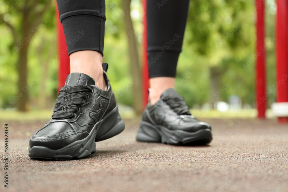 Woman in comfortable stylish sneakers outdoors, closeup Woman in comfortable stylish sneakers outdoors, closeup
