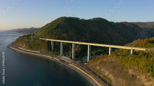 large bridge for motorway across sea, aerial view of drone slide turn, design of the automotive bridge in sea. Travel. Flying Over Bridge as Cars Pass. Sochi, Russia