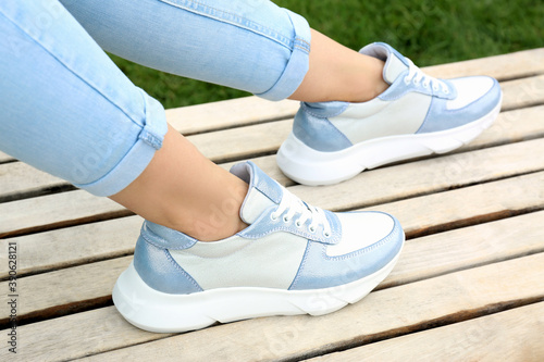 Woman wearing comfortable stylish sneakers outdoors, closeup
