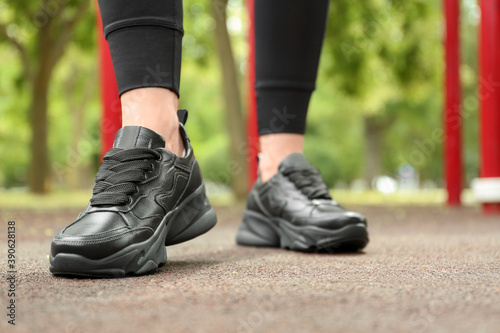 Woman in comfortable stylish sneakers outdoors, closeup