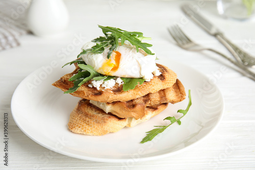 Delicious sandwich with arugula and egg on white wooden table, closeup