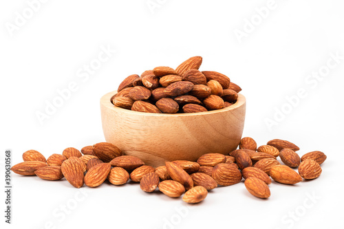 Almond in a wooden cup isolated on white background , It a healthy snack high energy © Amornsak