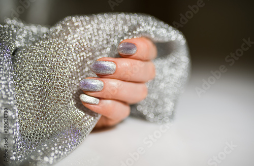 Nails Design. Hands With Bright Silver Christmas Manicure. Close Up Of Female Hands. Art Nail.