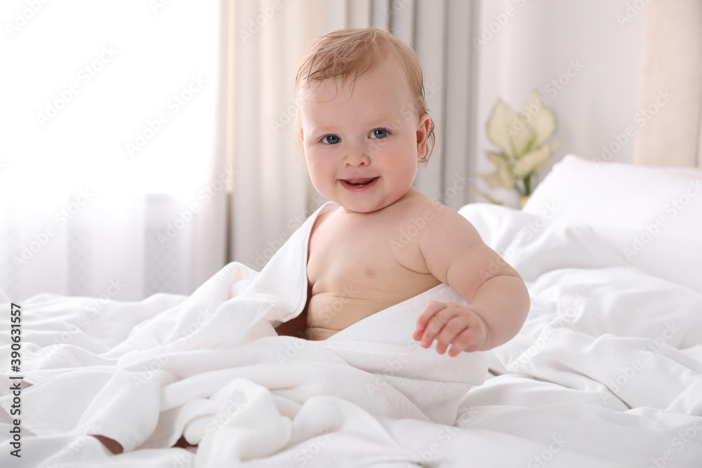 Cute little baby with soft towel on bed after bath Cute little baby with soft towel on bed after bath
