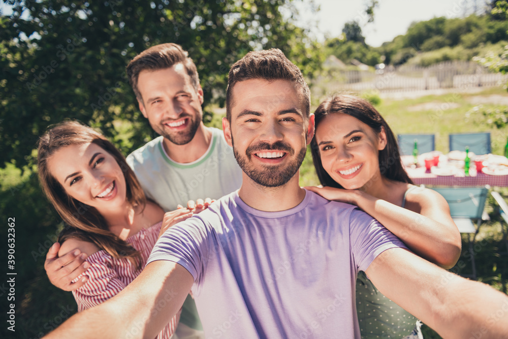 Photo of company four members smiling recording selfie video camera outside outdoors garden park forest