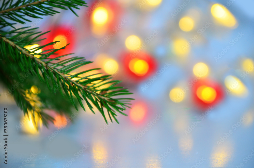 branch of a Christmas tree on a background of Christmas lights new year background, no focus, blur, blurry Closeup of Christmas tree background