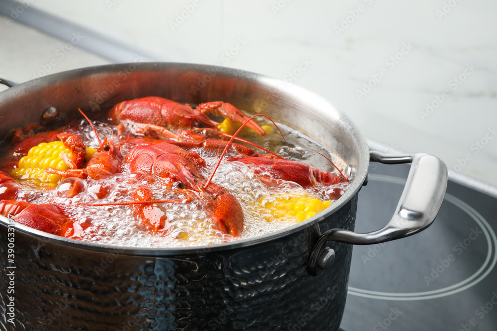 Fresh delicious crayfishes in boiling water on stove Fresh delicious crayfishes in boiling water on stove