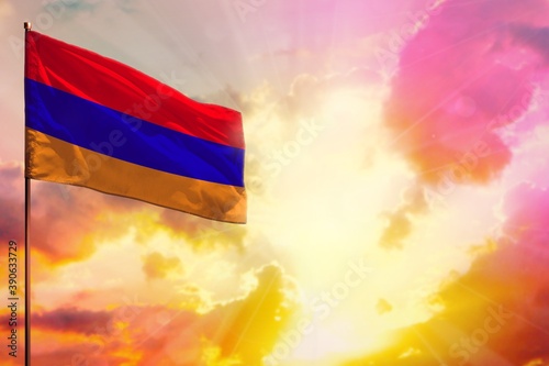 Fluttering Armenia flag in top left corner mockup with the space for your text on beautiful colorful sunset or sunrise background.