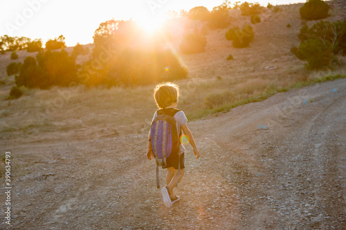 4 year old boy hiking at sunset, Lamy, New Mexico photo