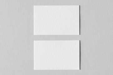 Textured business card mockup on a grey background.  85x55 mm.