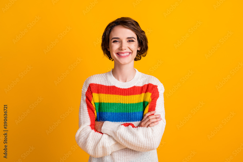 Photo of charming young lady crossed hands shiny smile wear striped sweater isolated yellow color background Photo of charming young lady crossed hands shiny smile wear striped sweater isolated yellow color background
