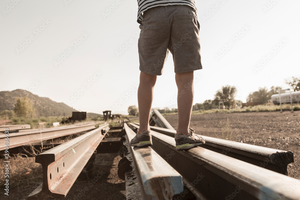 4 year old boy playing on railroad tracks, Lamy, New Mexico. 4 year old boy playing on railroad tracks, Lamy, New Mexico.
