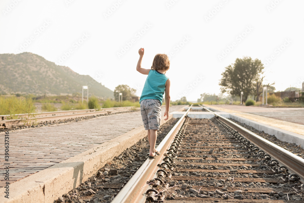4 year old boy balancing on railroad track, Lamy, New Mexico. 4 year old boy balancing on railroad track, Lamy, New Mexico.
