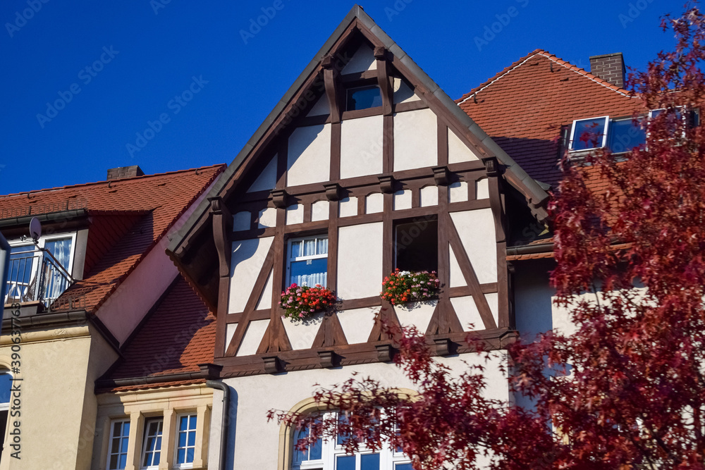 Facade of private house with open windows and tiled roof in Germany