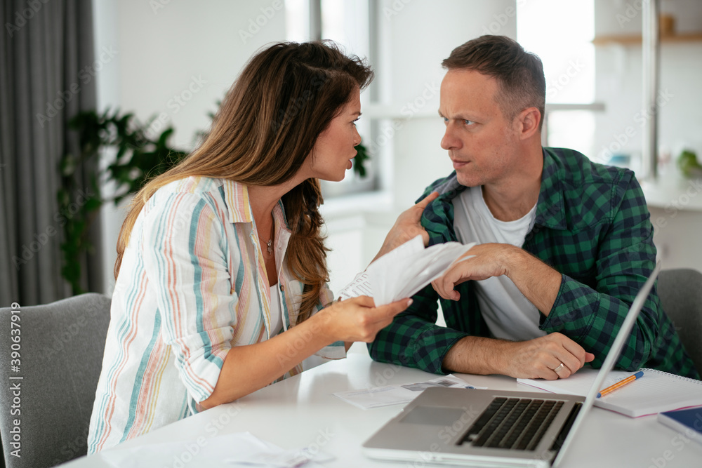 Husband and wife preparing bills to pay. Young couple using laptop.. Husband and wife preparing bills to pay. Young couple using laptop..