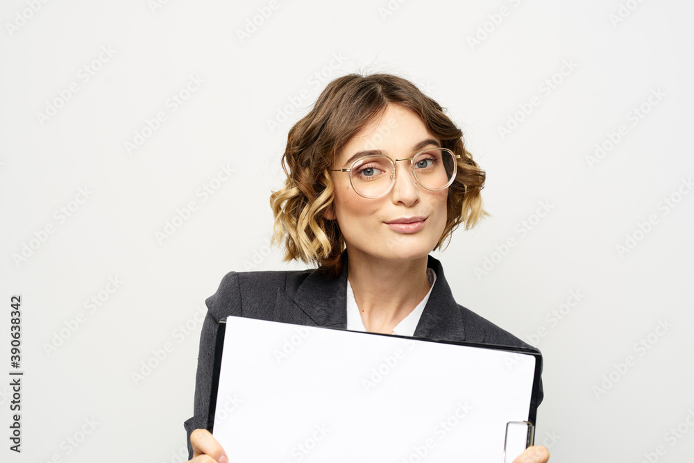 Business woman with a folder of documents on a light background cropped view and shirt suit Business woman with a folder of documents on a light background cropped view and shirt suit
