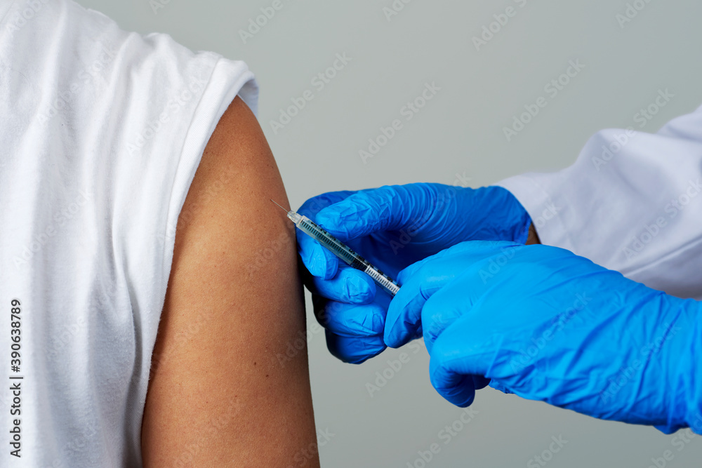 Fototapeta premium doctor man vaccinating a young man