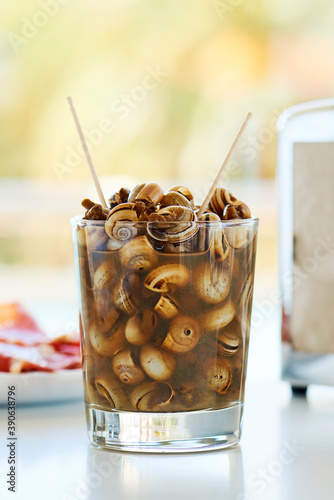 caracolillos en caldo, spanish recipe of snails photo