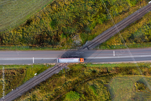 aerial top down view on railroad crossing with asphalt road