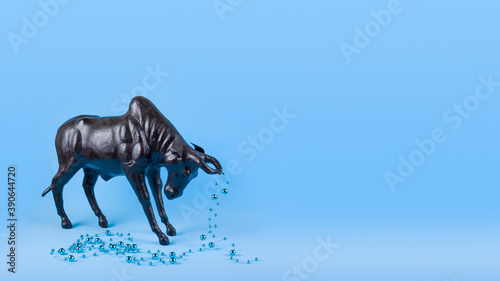 Ox with Christmas ball on horns on blue background, banner. Buffalo, bull as symbol of year 2021 to Chinese calendar. Merry christmas and new year greeting card