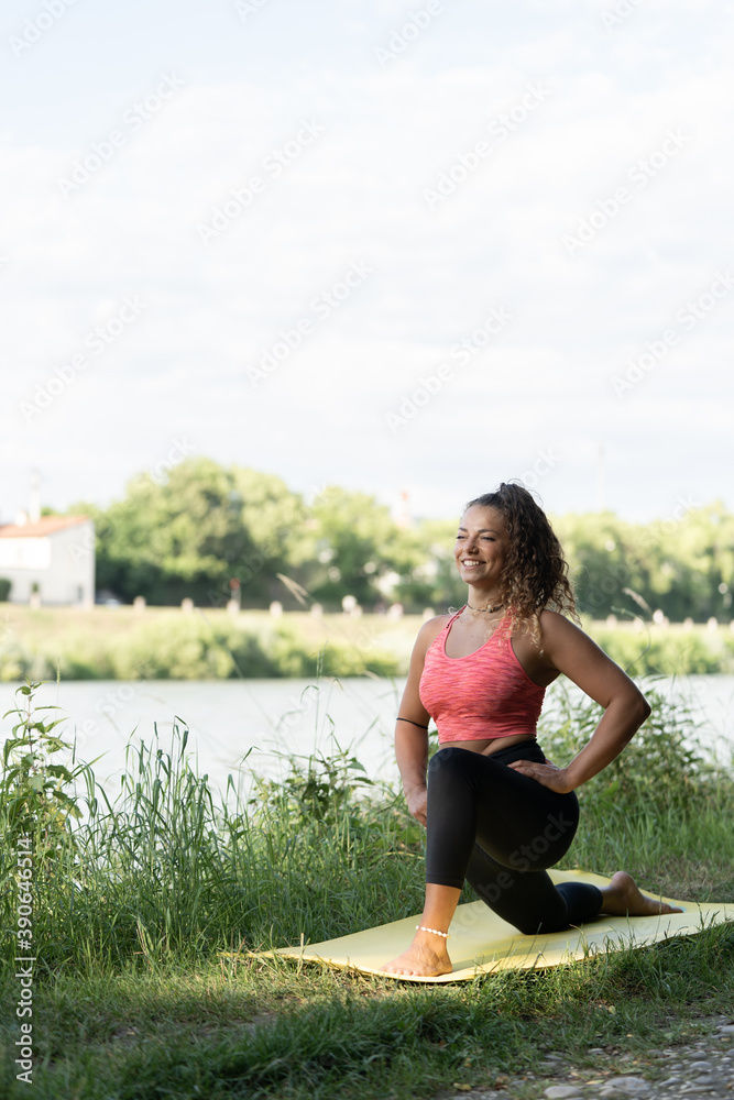 girl or woman doing sports outdoors near a river, nature