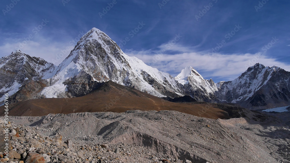 Stunning panorama view of mighty snow-capped mountain Pumori (summit 7,161 m) with Kala Patthar (5,645 m) below and famous Khumbu glacier on challenging Everest Base Camp Trek in the Himalayas, Nepal.