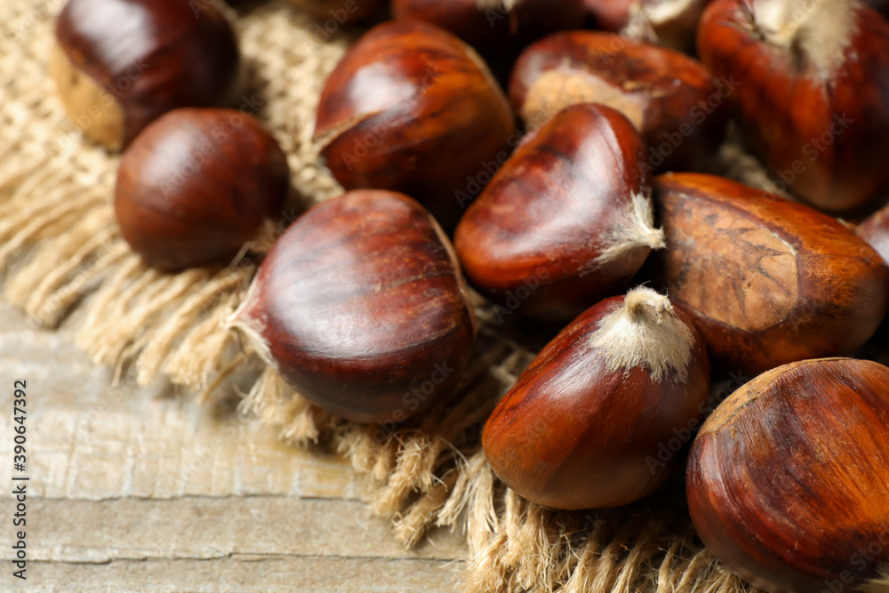 Fresh sweet edible chestnuts on wooden table, closeup Fresh sweet edible chestnuts on wooden table, closeup