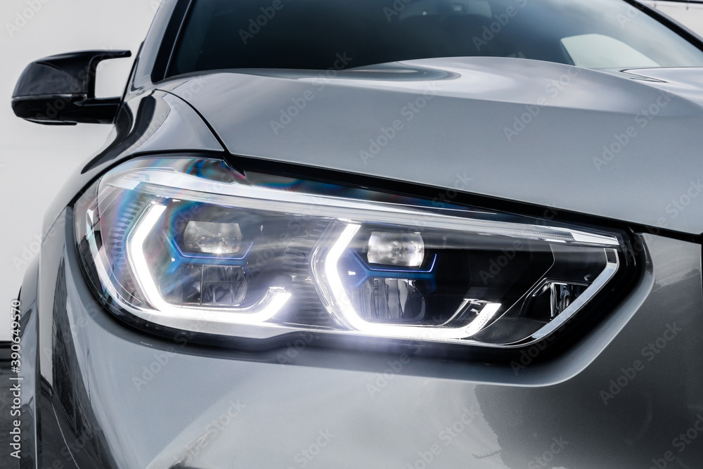 Mock-up, banner for car advertising. Silver new car front view: xenon headlight, side mirror, bumper and hood on white isolated background Mock-up, banner for car advertising. Silver new car front view: xenon headlight, side mirror, bumper and hood on white isolated background