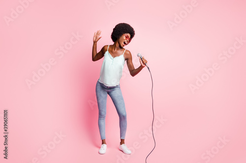 Full size photo of attractive lady singing have fun wear blue tank-top isolated on pink color background