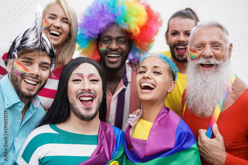 Portrait of happy multiracial people at gay pride event with lgbt rainbow flag