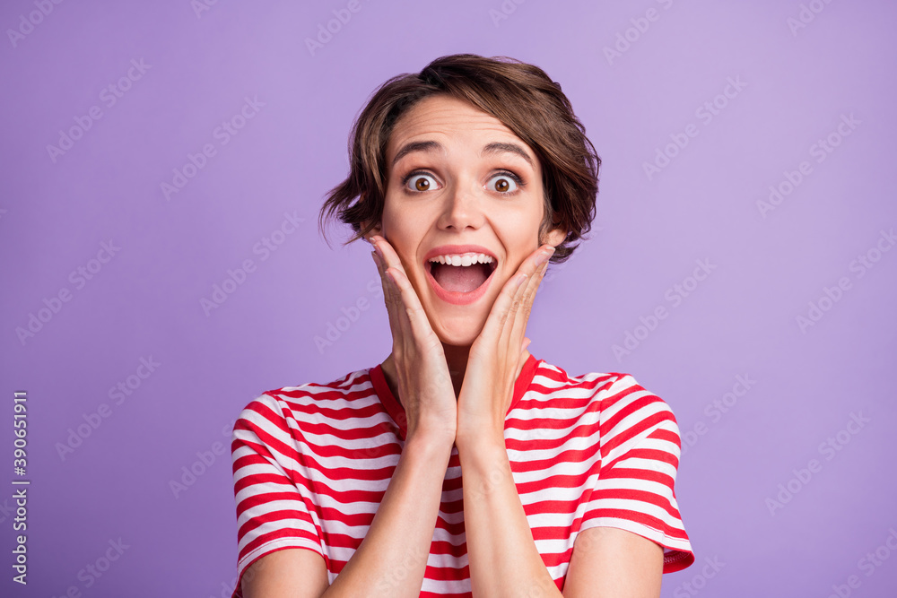 Photo of cute young lady open mouth palms cheekbones wear striped t-shirt isolated purple color background Photo of cute young lady open mouth palms cheekbones wear striped t-shirt isolated purple color background