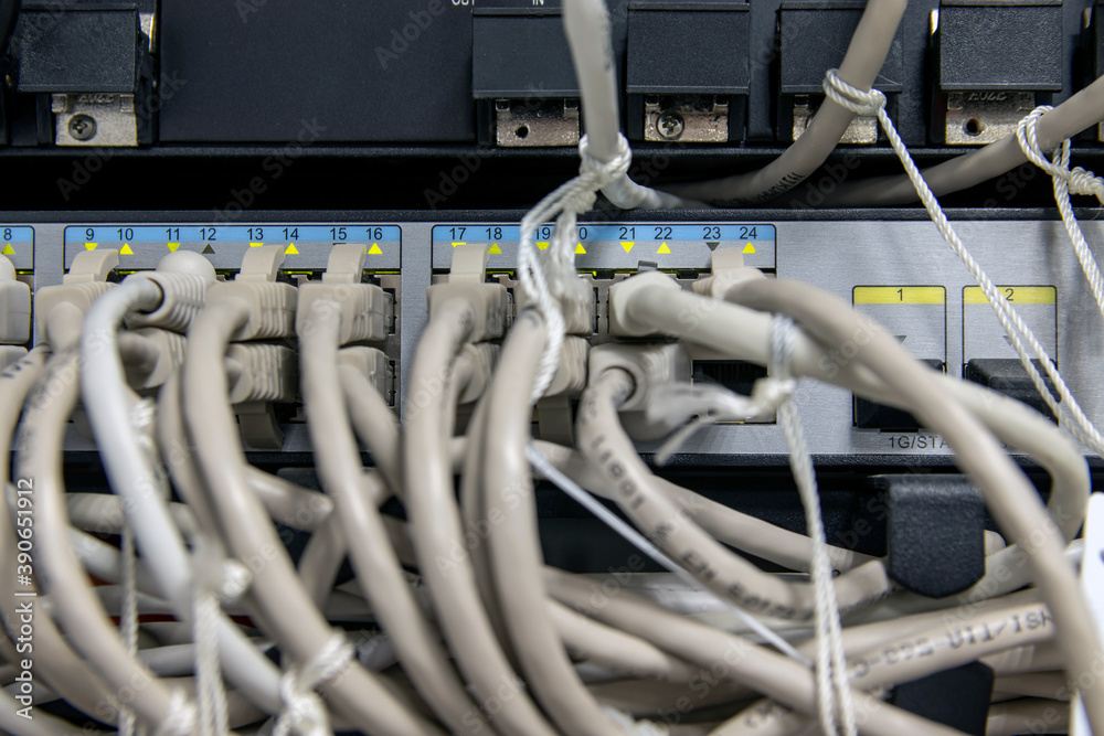 Network hardware. Data transmission in progress, colored indicators are on. Optical fiber. The cables are connected to network equipment. Server close-up. Fragment of server equipment. 