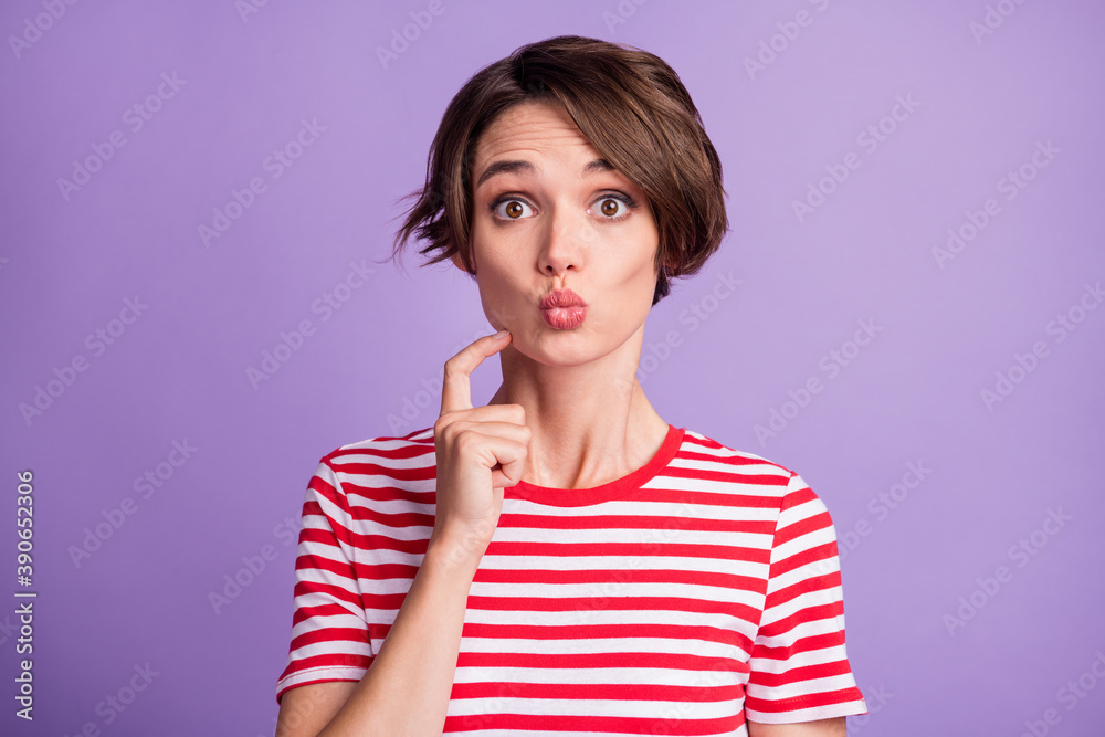 Photo of lovely young girl finger cheekbone pouted lips staring wear striped t-shirt isolated purple color background Photo of lovely young girl finger cheekbone pouted lips staring wear striped t-shirt isolated purple color background