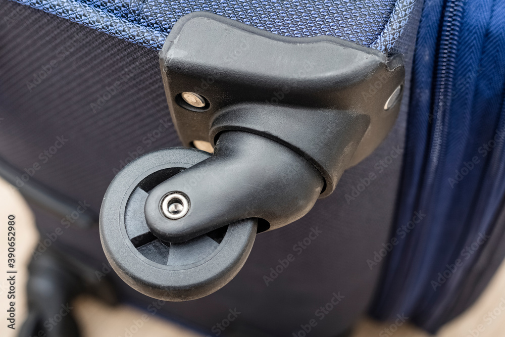 Naklejka premium Repair of bags and suitcases on wheels. Detail of a travel suitcase. Close-up