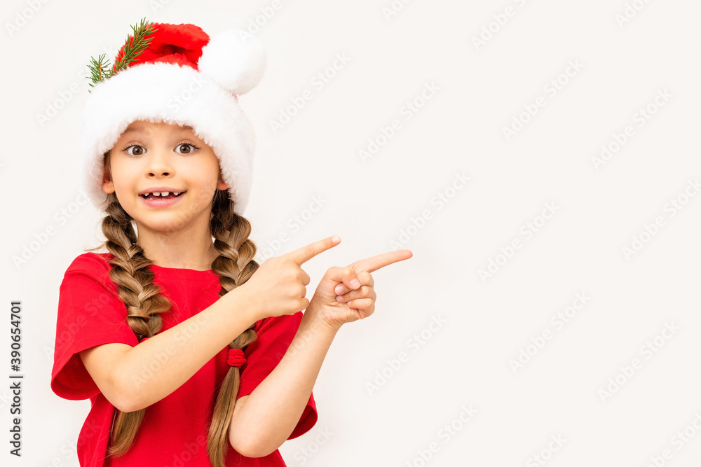 A little girl in a red t-shirt and a Christmas hat points to your ad. A little girl in a red t-shirt and a Christmas hat points to your ad.