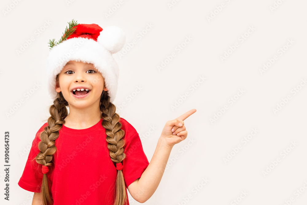 A little girl in a red t-shirt and a Christmas hat points to your ad. A little girl in a red t-shirt and a Christmas hat points to your ad.
