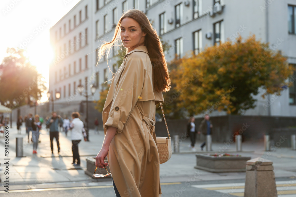 confident woman walking in autumn in the center of a big city. urban portrait of successful business woman