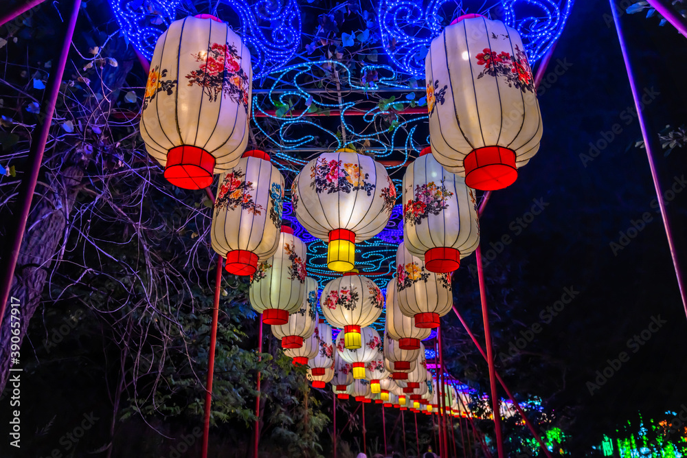 A tunnel of Chinese lanterns at night