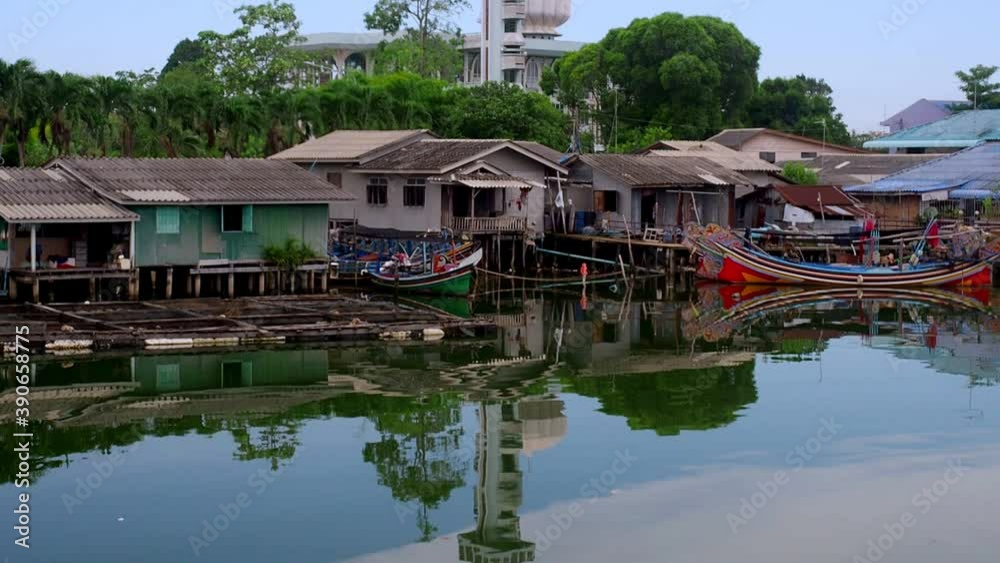 Muslim mosque and fisherman village reflection on calm water. Muslim mosque and fisherman village reflection on calm water.