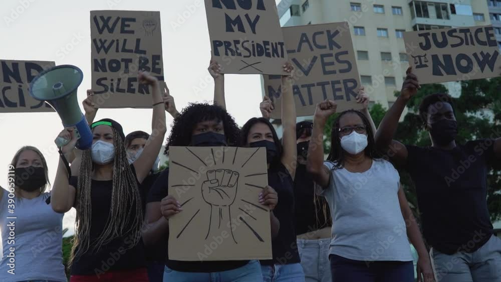 Activist movement protesting against racism and fighting for equality - Demonstrators from different cultures and race protest on street for equal rights - Black lives matter protests city concept