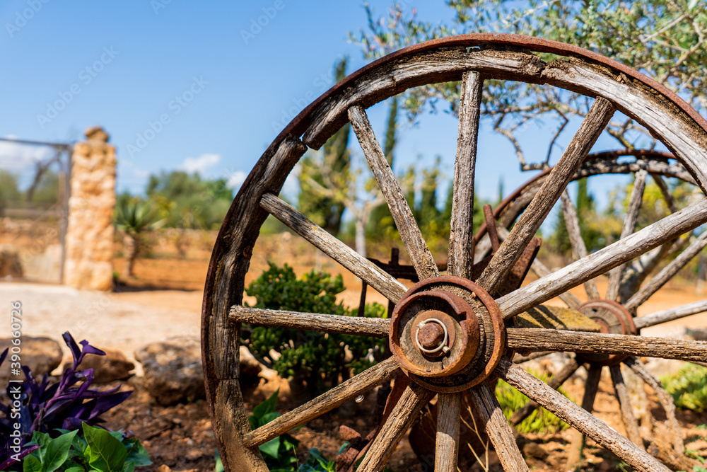 Wooden wheel for antique carriage in country house decorating the garden Wooden wheel for antique carriage in country house decorating the garden