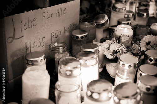 Hanau, Germany - February 20 2020: Flowers and Candles at the Hanau shooting site as a remembrance to the victims. Right extremism. Terror attack.