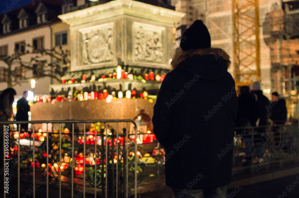 Hanau, Germany - February 20 2020: Flowers and Candles at the Hanau shooting site as a remembrance to the victims. Right extremism. Terror attack. - obrazy, fototapety, plakaty 