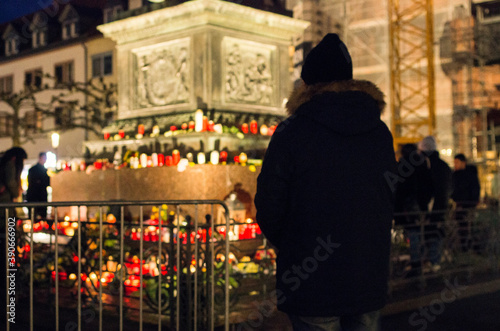 Hanau, Germany - February 20 2020: Flowers and Candles at the Hanau shooting site as a remembrance to the victims. Right extremism. Terror attack.