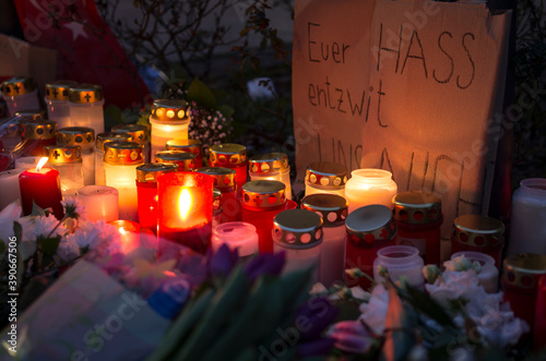 Hanau, Germany - February 20 2020: Flowers and Candles at the Hanau shooting site as a remembrance to the victims. Right extremism. Terror attack.