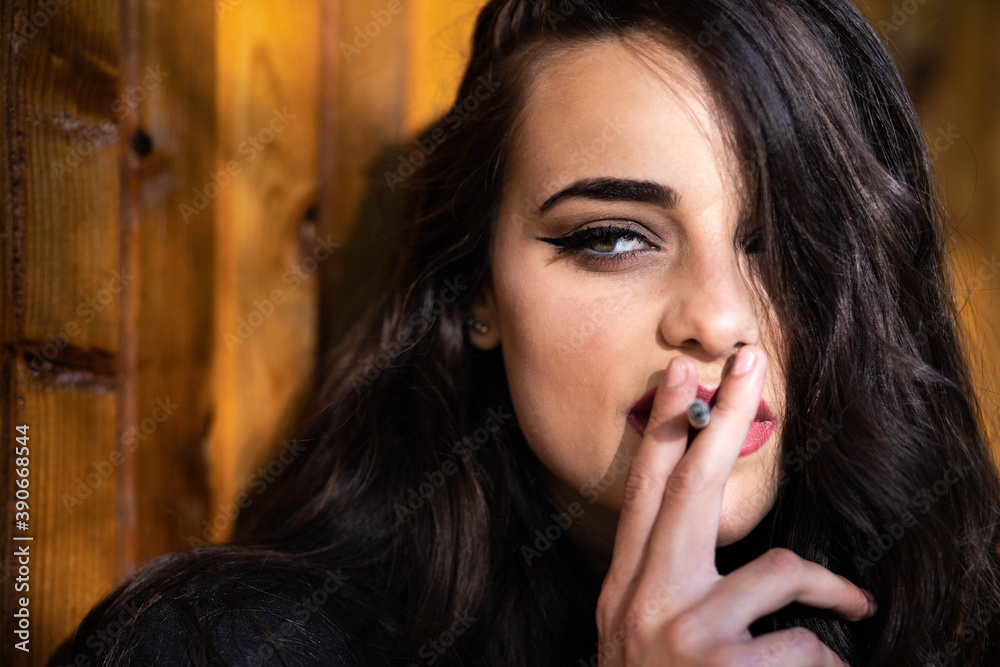 Portrait of a beautiful brunette girl smoking Portrait of a beautiful brunette girl smoking