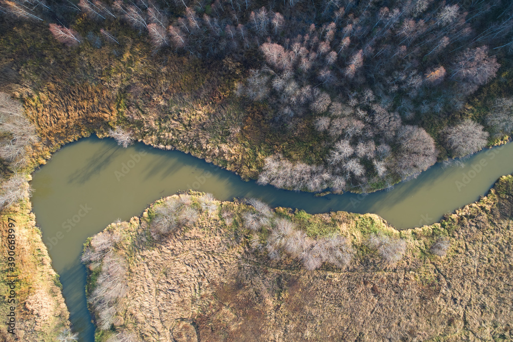 Beautiful landscape with a winding river and forest in the sun. Aerial photography using a drone